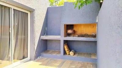 a cat sitting in a cat house next to a window at Depto en la Sierra!! Barrio Villa del Lago con vista a los Gigantes in Villa Carlos Paz