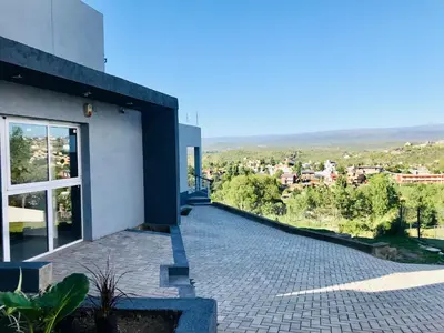 a balcony of a building with a view of a city at Depto en la Sierra!! Barrio Villa del Lago con vista a los Gigantes in Villa Carlos Paz