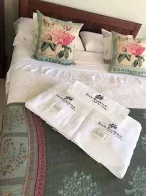 two white towels are sitting on a bed at las brisas casas de campo un lugar para soñar in San Antonio de Arredondo