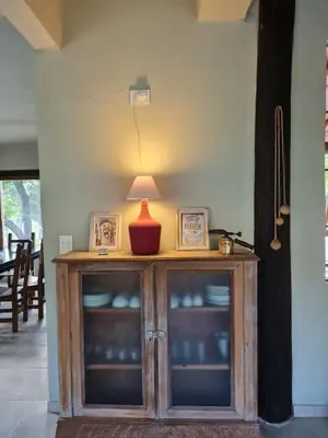 a wooden cabinet with a lamp on top of it at las brisas casas de campo un lugar para soñar in San Antonio de Arredondo