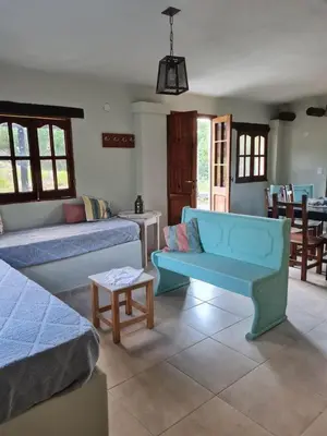 a living room with a blue couch and a table at las brisas casas de campo un lugar para soñar in San Antonio de Arredondo
