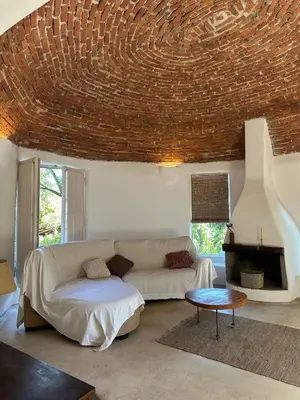 a living room with a couch and a fireplace at casa cupulas in Cordoba