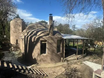 an outside view of a house shaped like a mushroom at casa cupulas in Cordoba