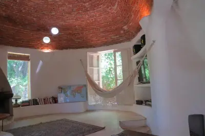 a living room with a wicker ceiling at casa cupulas in Cordoba