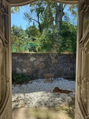 an open door with a bench in front of a stone wall at casa cupulas in Cordoba