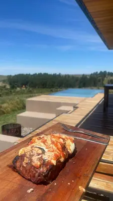 a piece of food sitting on a wooden table at Cabaña La Alemana in Villa Berna