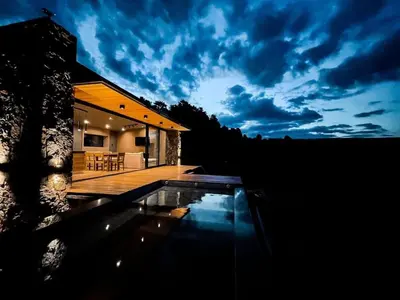 a house with a swimming pool in front of it at Cabaña La Alemana in Villa Berna