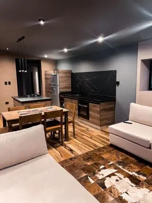 a living room with a couch and a table at Cabaña La Alemana in Villa Berna