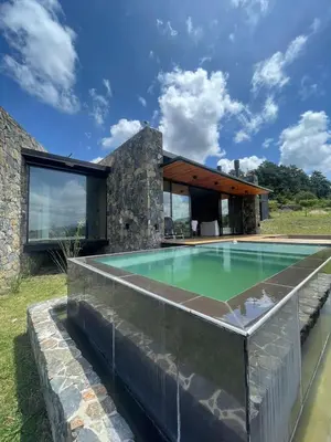 a house with a swimming pool in front of it at Cabaña La Alemana in Villa Berna