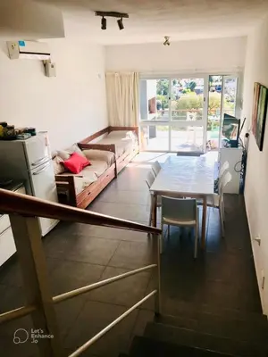 a living room with a table and a couch at Lofts en la Sierra!! Excelente vista a los Gigantes in Villa Carlos Paz