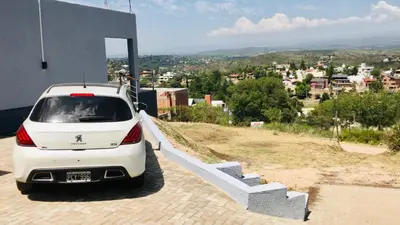 a white car parked on the side of a building at Lofts en la Sierra!! Excelente vista a los Gigantes in Villa Carlos Paz
