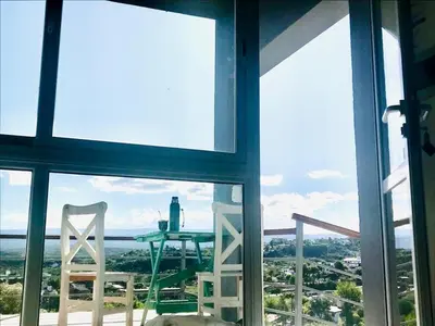a view of a table and chairs from a window at Lofts en la Sierra!! Excelente vista a los Gigantes in Villa Carlos Paz