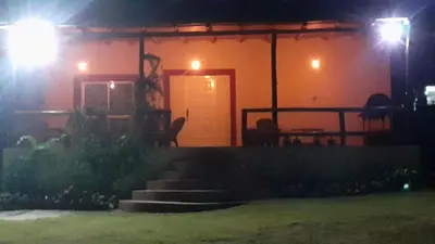 a house with a cat sitting on the stairs at night at Casa con Gran Patio in Villa Parque Siquiman