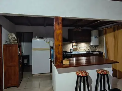 a kitchen with a white refrigerator and a counter at Casa con Gran Patio in Villa Parque Siquiman