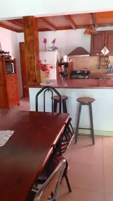 a kitchen with a wooden table and a counter at Casa con Gran Patio in Villa Parque Siquiman