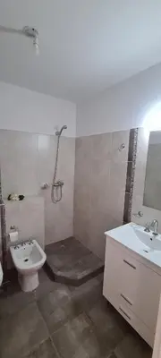 a bathroom with a sink and a shower and a toilet at Carlos Paz - 3 Dormitorios con cochera - Zona céntrica residencial in Villa Carlos Paz