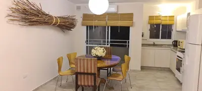a kitchen with a dining room table and chairs at Carlos Paz - 3 Dormitorios con cochera - Zona céntrica residencial in Villa Carlos Paz