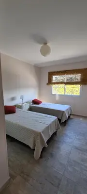 a bedroom with two beds and a window at Carlos Paz - 3 Dormitorios con cochera - Zona céntrica residencial in Villa Carlos Paz