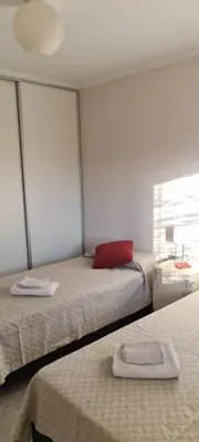a room with two beds and a window at Carlos Paz - 3 Dormitorios con cochera - Zona céntrica residencial in Villa Carlos Paz