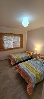 a bedroom with two beds and a window at Carlos Paz - 3 Dormitorios con cochera - Zona céntrica residencial in Villa Carlos Paz