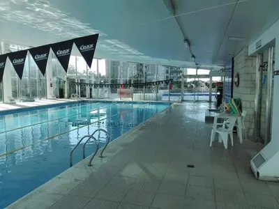 a large swimming pool in a large building at Departamento 1 dormitorio en complejo con amenities - Córdoba Ciudad in Cordoba