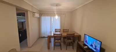 a living room with a dining room table and a television at Departamento 1 dormitorio en complejo con amenities - Córdoba Ciudad in Cordoba