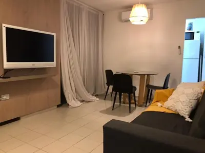 a living room with a couch and a tv and a table at AYACUCHO APART. in Cordoba