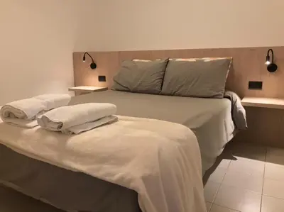 a bed with two pillows on it in a room at AYACUCHO APART. in Cordoba
