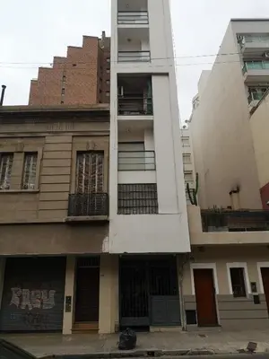 an apartment building with balconies on a city street at AYACUCHO APART. in Cordoba