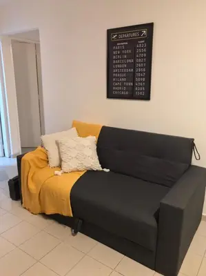 a couch in a room with a sign on the wall at AYACUCHO APART. in Cordoba