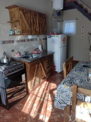 a kitchen with a sink and a stove and a refrigerator at LUNA DE MERLO in Merlo