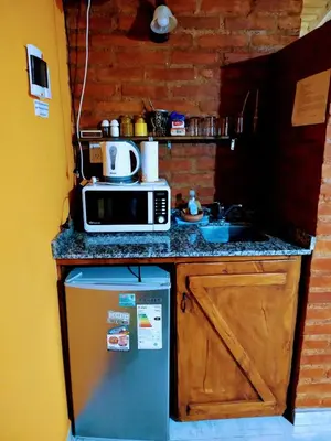 a small kitchen with a microwave and a sink at LUNA DE MERLO in Merlo