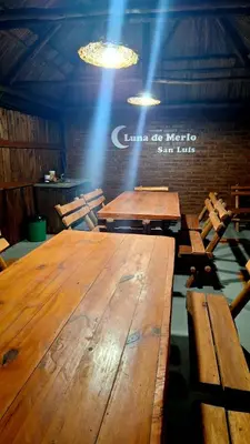 a large wooden table in a room with lights at LUNA DE MERLO in Merlo