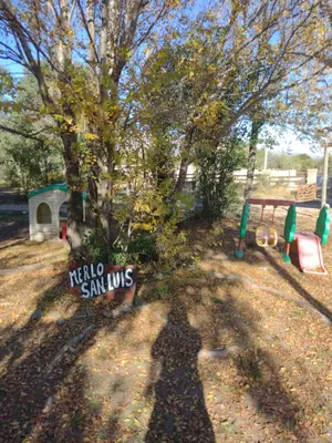 a shadow of a sign next to a playground at LUNA DE MERLO in Merlo