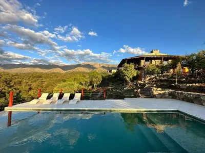 a swimming pool with lounge chairs and a house at ACHIRAS SUNSET in San Javier