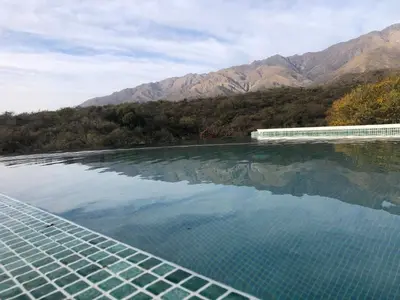 a pool of water with mountains in the background at ACHIRAS SUNSET in San Javier