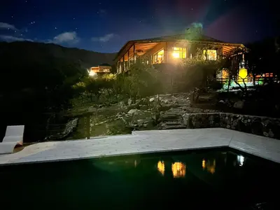 a house at night with a swimming pool in front of it at ACHIRAS SUNSET in San Javier