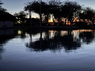 a large body of water with the sun setting at ACHIRAS SUNSET in San Javier