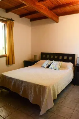 a bedroom with a large bed with two pillows at El jagüel in Villa General Belgrano