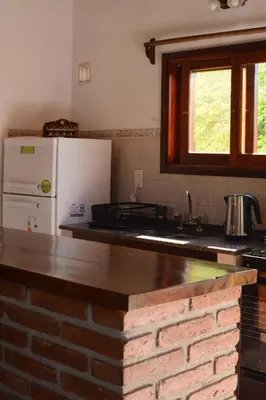 a kitchen with a brick counter top and a refrigerator at El jagüel in Villa General Belgrano