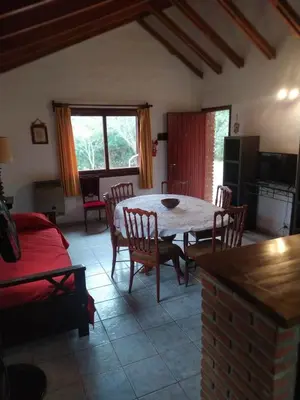 a kitchen and dining room with a table and chairs at El jagüel in Villa General Belgrano