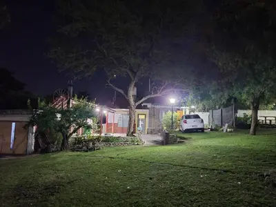 a house with a car parked in a yard at night at El Remanso Estadia Minima 2 Noches in Cordoba