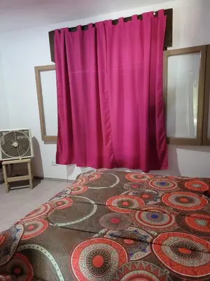 a bed with a pink curtain in a room at El Remanso Estadia Minima 2 Noches in Cordoba