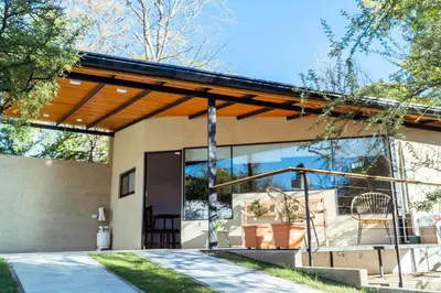 a modern house with a glass facade at Complejo Quiya - Departamento Los Espinillos con hidromasaje in Alta Gracia