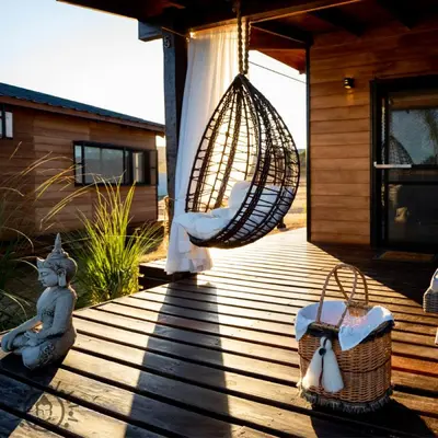 a porch with a hammock and a swing at OMM Suites Resort, Villa General Belgrano in Villa General Belgrano