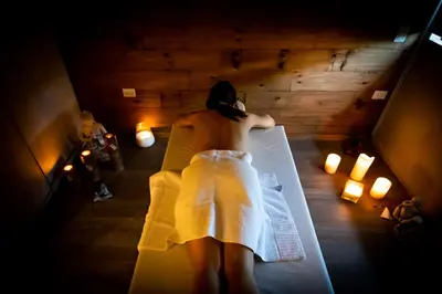 a woman in a white dress sitting on a bed at OMM Suites Resort, Villa General Belgrano in Villa General Belgrano