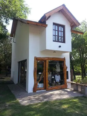 a small house with a large window in front of it at Lola Maria Apart in Villa General Belgrano