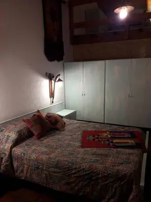 a bedroom with a bed with pillows on it at Lola Maria Apart in Villa General Belgrano