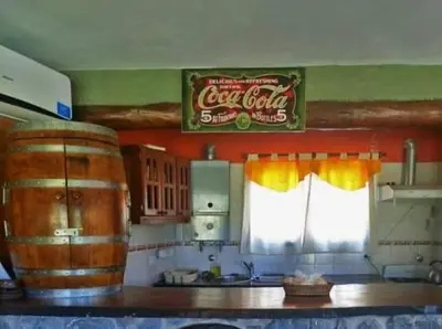 a kitchen with a cocacola sign on the wall at El Rancho Casa de Campo Exclusiva en Villa de Las Rosas Los impuestos que figuran en la publicación no se cobran in Villa de Las Rosas