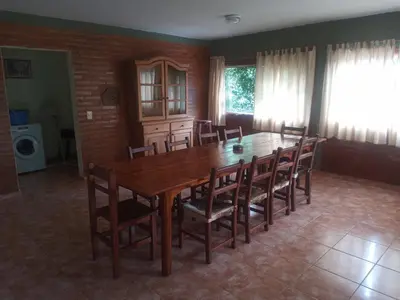 a dining room with a wooden table and chairs at El Rancho Casa de Campo Exclusiva en Villa de Las Rosas Los impuestos que figuran en la publicación no se cobran in Villa de Las Rosas